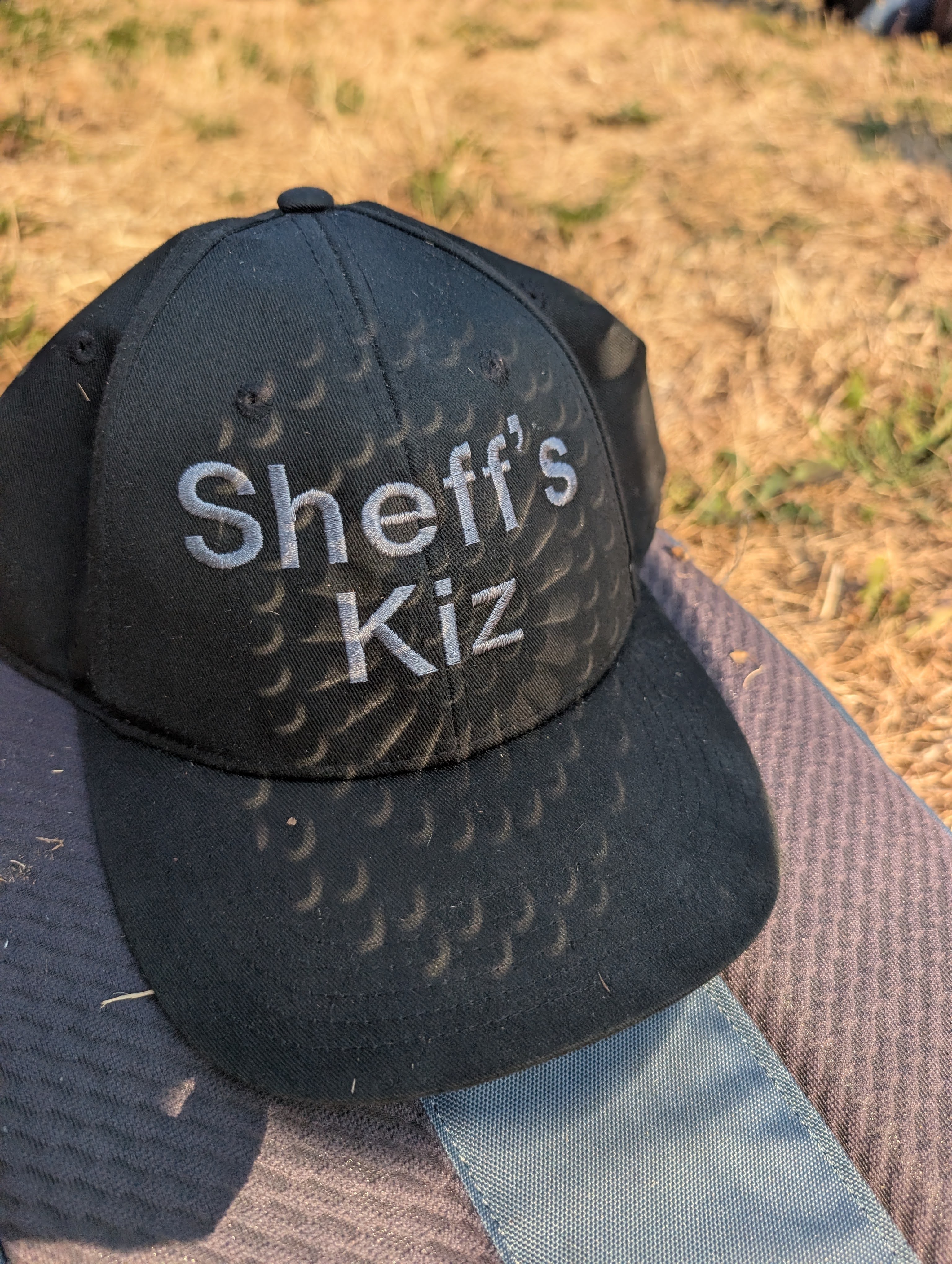 Sheff's Kiz cap with crescent eclipse shadows across the brim