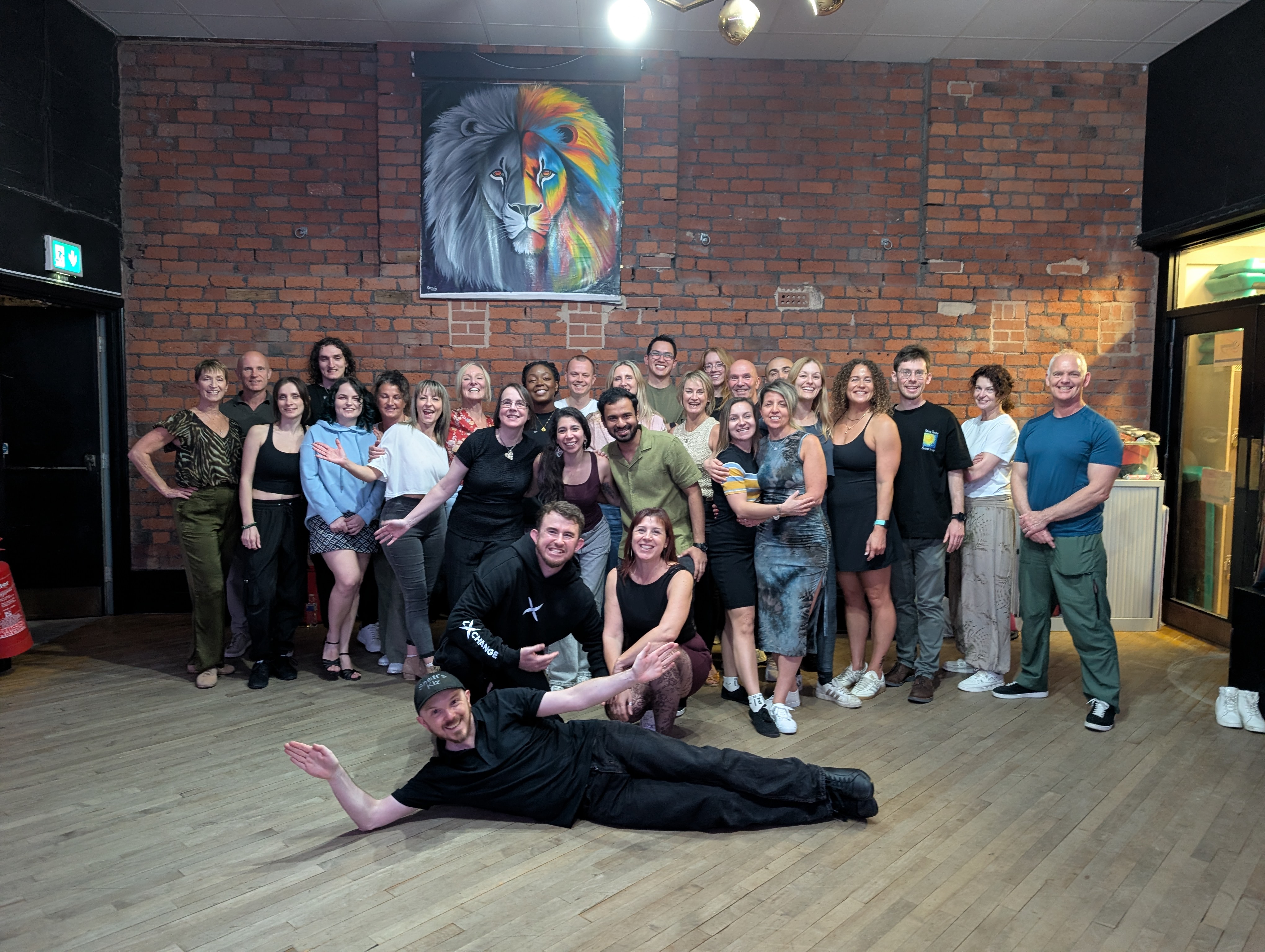 Sheff's Kiz group photo in a brick-walled hall