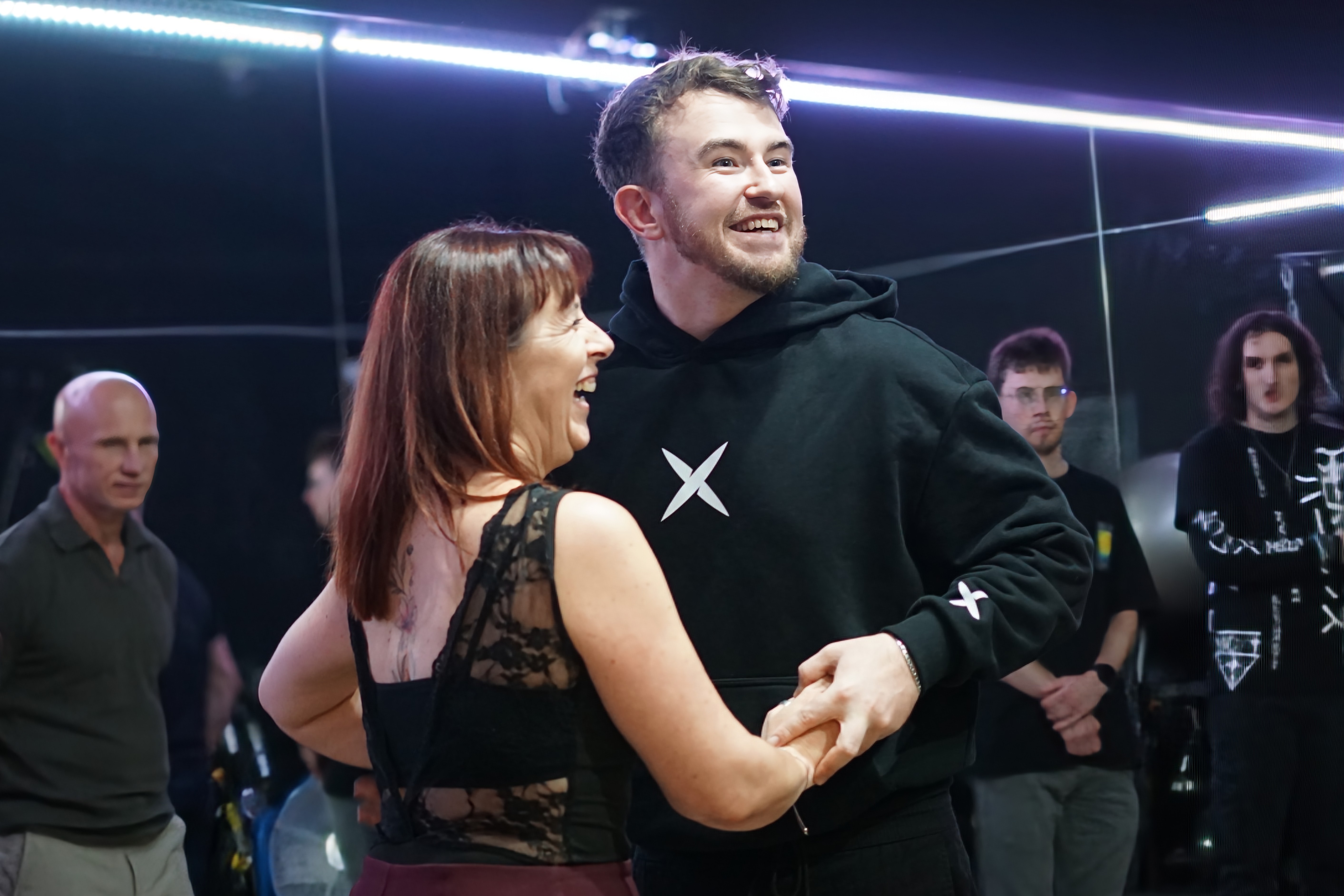 Couple dancing and laughing on the social floor